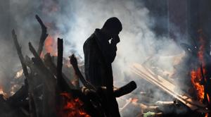 A man cries as he stands next to the burning pyre of a family member who died after a train travelling at high speed ran through a crowd of people on the rail tracks on Friday, at a cremation ground in Amritsar, October 20, 2018.(REUTERS) A man cries as he stands next to the burning pyre of a family member who died after a train travelling at high speed ran through a crowd of people on the rail tracks on Friday, at a cremation ground in Amritsar, October 20, 2018.(REUTERS)