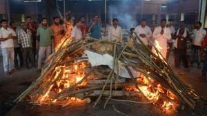 Relatives stand next to burning pyres of a man who was killed when a train ploughed into a crowd of Dussehra revellers, at a cremation ground in Amritsar on October 20, 2018.(AFP) Relatives stand next to burning pyres of a man who was killed when a train ploughed into a crowd of Dussehra revellers, at a cremation ground in Amritsar on October 20, 2018.(AFP)