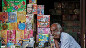 A shopkeeper waits for customers at his firecracker shop in Delhi.(REUTERS) A shopkeeper waits for customers at his firecracker shop in Delhi.(REUTERS)