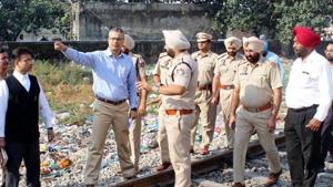 Jalandhar divisional commissioner B Purushartha (left) with cops inspecting the accident site in Amritsar on Thursday.(HT Photo)
