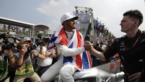British driver Lewis Hamilton celebrates wining his fourth Formula One championship with a member of his team after the Mexican Formula One Grand Prix auto race at the Hermanos Rodriguez racetrack in Mexico City.(AP) British driver Lewis Hamilton celebrates wining his fourth Formula One championship with a member of his team after the Mexican Formula One Grand Prix auto race at the Hermanos Rodriguez racetrack in Mexico City.(AP)