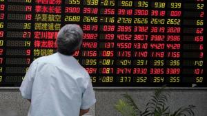 A man looks at an electronic board showing stock information.(REUTERS) A man looks at an electronic board showing stock information.(REUTERS)