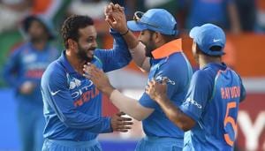 Indian cricketer Kedar Jadhav (L) celebrates with his teammates(AFP)