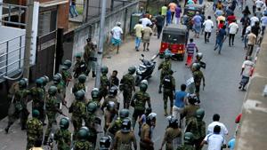 Members of Sri Lanka's Special Task Force and the police chase away supporters of Sri Lanka's newly appointed Prime Minister Mahinda Rajapaksa after an official security guard of sacked minister Arjuna Ranatunga shot and killed one person in front of the Ceylon Petroleum Corporation, in Colombo.(REUTERS) Members of Sri Lanka's Special Task Force and the police chase away supporters of Sri Lanka's newly appointed Prime Minister Mahinda Rajapaksa after an official security guard of sacked minister Arjuna Ranatunga shot and killed one person in front of the Ceylon Petroleum Corporation, in Colombo.(REUTERS)