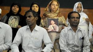 Relatives pose with photos of Hashimpura massacre victims in New Delhi.(Saumya Khandelwal/HT Photo) Relatives pose with photos of Hashimpura massacre victims in New Delhi.(Saumya Khandelwal/HT Photo)