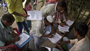 People whose names were left out in the National Register of Citizens (NRC) draft fill their forms to file appeals near a NRC center on the outskirts of Guwahati.(AP File Photo) People whose names were left out in the National Register of Citizens (NRC) draft fill their forms to file appeals near a NRC center on the outskirts of Guwahati.(AP File Photo)
