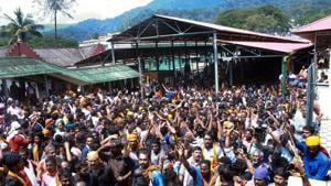 Protests erupted in Sabarimala temple in Kerala’s Pathanamthitta on Tuesday after a woman reached near the 18 holy steps of the hilltop shrine and agitators heckled her over her age.(PTI) Protests erupted in Sabarimala temple in Kerala’s Pathanamthitta on Tuesday after a woman reached near the 18 holy steps of the hilltop shrine and agitators heckled her over her age.(PTI)