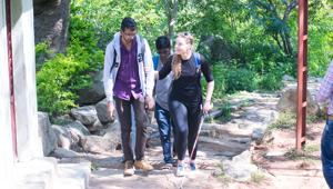 Cambria Sawyer from the Bikat Adventures team helps a blind individual during the trek. Cambria Sawyer from the Bikat Adventures team helps a blind individual during the trek.