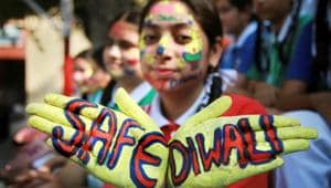 A student displays a message painted on her hands to create awareness regarding the hazardous effects of air pollution during Diwali in Jammu(PTI)