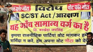 A banner in Barkheda Jaising, a village in MP’s Mandaur district. A section of the party’s core voters is unhappy with the BJP over amendments to the SC/ST act and reservations. They are, for the first time in 15 years, actively voicing these concerns.(HT Photo)