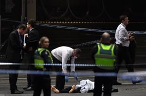 A police officer (C) inspects a body at the crime scene following a stabbing incident in Melbourne on November 9.(AFP Photo) A police officer (C) inspects a body at the crime scene following a stabbing incident in Melbourne on November 9.(AFP Photo)