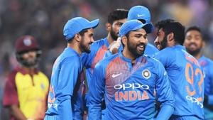 Indian T20 cricket captain Rohit Sharma (C) celebrates with teammates the wicket of West Indies cricketer Shai Hope during the first T20 cricket match between India and West Indies(AFP)
