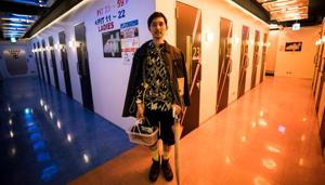 Masaki Kitakoga poses next to tiny booths after singing, at a karaoke parlour in Tokyo. Kitakoga is part of a growing trend in Japan favouring solo activities that is now so widespread it has its own name 