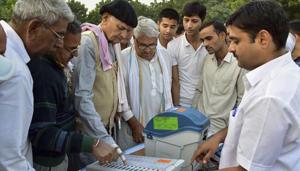 Election officials demonstrate the functioning of an Electronic Voting Machine (EVM) and Voter-Verified Paper Audit Trail (VVPAT) to the locals during a voter awareness programme ahead of Rajasthan State Assembly elections, in Bikaner, Oct 30, 2018. The state will vote on December 7.(PTI File)