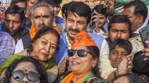 BJP activists take a selfie with Delhi BJP chief Manoj Tiwari during a campaign in Dehradun on Wednesday.(PTI)