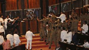 Lawmakers supporting disputed Prime Minister Rajapksa throw a chair towards police officers escorting the speaker inside parliament in Colombo, Sri Lanka, Friday, Nov. 16, 2018.(AP) Lawmakers supporting disputed Prime Minister Rajapksa throw a chair towards police officers escorting the speaker inside parliament in Colombo, Sri Lanka, Friday, Nov. 16, 2018.(AP)