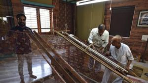 Two generations of a Salvi family work the loom to create the double ikat Patola, that is made only in Patan.(Sanchit Khanna/HT PHOTO) Two generations of a Salvi family work the loom to create the double ikat Patola, that is made only in Patan.(Sanchit Khanna/HT PHOTO)