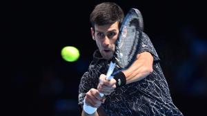 Novak Djokovic returns against Croatia's Marin Cilic in their men's singles round-robin match.(AFP) Novak Djokovic returns against Croatia's Marin Cilic in their men's singles round-robin match.(AFP)