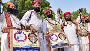 Rajasthani artists display their moustache during an election awareness campaign, in Bikaner, Thursday, Nov. 15, 2018. A couple has filed their nomination as independent candidates from Bikaner East seat.(PTI) Rajasthani artists display their moustache during an election awareness campaign, in Bikaner, Thursday, Nov. 15, 2018. A couple has filed their nomination as independent candidates from Bikaner East seat.(PTI)