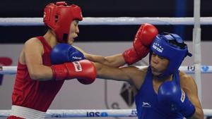 Mary Kom of India (in blue) and Kim Hyang Mi of North Korea (in red) compete during their 45-48 kg category semi-final fight.(AFP) Mary Kom of India (in blue) and Kim Hyang Mi of North Korea (in red) compete during their 45-48 kg category semi-final fight.(AFP)