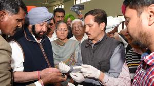 Indian security personnel show fragments of a grenade to Punjab Chief Minister Amarinder Singh (2R), following a grenade attack at the Nirankari Satsang Bhawan in Rajasansi village, on the outskirts of Amritsar(AFP) Indian security personnel show fragments of a grenade to Punjab Chief Minister Amarinder Singh (2R), following a grenade attack at the Nirankari Satsang Bhawan in Rajasansi village, on the outskirts of Amritsar(AFP)