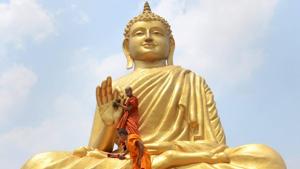 Buddhists monks clean a statue of Lord Buddha in West Bengal. (Representational Photo)(PTI Photo) Buddhists monks clean a statue of Lord Buddha in West Bengal. (Representational Photo)(PTI Photo)