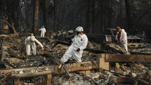 Search and rescue personnel search a home for human remains in the aftermath of the Camp Fire, in Paradise, California.(AP) Search and rescue personnel search a home for human remains in the aftermath of the Camp Fire, in Paradise, California.(AP)