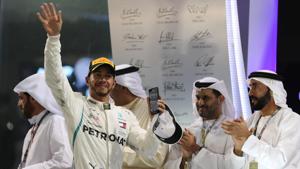 Mercedes' Lewis Hamilton celebrates winning the race on the podium.(REUTERS) Mercedes' Lewis Hamilton celebrates winning the race on the podium.(REUTERS)