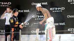 Mercedes' Lewis Hamilton celebrates winning the race on the podium with second place Red Bull's Max Verstappen at the Abu Dhabi Grand Prix.(REUTERS) Mercedes' Lewis Hamilton celebrates winning the race on the podium with second place Red Bull's Max Verstappen at the Abu Dhabi Grand Prix.(REUTERS)