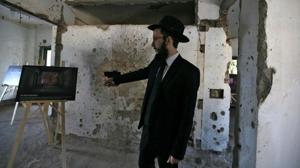 Rabbi Israel Kozlovsky points to a poster showing how the room will look like after its renovation following the renaming of Nariman House as Nariman Light House, which was one of the targets of the November 26, 2008 attacks.(Reuters) Rabbi Israel Kozlovsky points to a poster showing how the room will look like after its renovation following the renaming of Nariman House as Nariman Light House, which was one of the targets of the November 26, 2008 attacks.(Reuters)