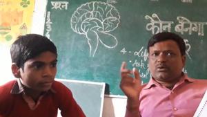 Donning the role of show’s host Amitabh Bachchan, teacher Ashutosh Anand Awasthi enacts the game show in the classroom, much to the delight of children.(HT Photo) Donning the role of show’s host Amitabh Bachchan, teacher Ashutosh Anand Awasthi enacts the game show in the classroom, much to the delight of children.(HT Photo)