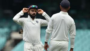 India's captain Virat Kohli (L) talks to Cheteshwar Pujara (R) whilst fielding on the third day of the tour match against Cricket Australia XI at the SCG in Sydney on November 30, 2018(AFP)