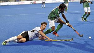 Germany's player Timm Herzbruch (white) and Shan Ali of Pakistan view for the ball during the Men's Hockey World Cup 2018.(PTI) Germany's player Timm Herzbruch (white) and Shan Ali of Pakistan view for the ball during the Men's Hockey World Cup 2018.(PTI)