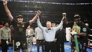Tyson Fury, left, of England, poses with Deontay Wilder, right, along with referee Jack Reiss after their WBC heavyweight championship boxing match ended in a draw.(AP) Tyson Fury, left, of England, poses with Deontay Wilder, right, along with referee Jack Reiss after their WBC heavyweight championship boxing match ended in a draw.(AP)