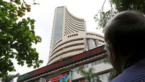 A man looks at a screen across a road displaying the Sensex on the facade of the Bombay Stock Exchange (BSE) building in Mumbai, India.(REUTERS) A man looks at a screen across a road displaying the Sensex on the facade of the Bombay Stock Exchange (BSE) building in Mumbai, India.(REUTERS)
