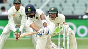 India vs Australia: India's captain Virat Kohli hits a ball as Australia's captain Tim Paine looks on during day three of the first Test.(AFP) India vs Australia: India's captain Virat Kohli hits a ball as Australia's captain Tim Paine looks on during day three of the first Test.(AFP)