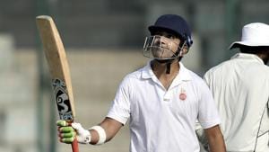 Delhi cricketer Gautam Gambhir raises his bat after scoring a century during the Ranji Trophy group league match between Delhi and Andhra at Feroz Shah Kotla Ground.(AP)