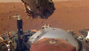 In this image obtained from NASA, InSight's robotic arm-mounted instrument deployment camera shows instruments on the spacecraft's deck, with the Martian surface of Elysium Planitia in the background.(AFP) In this image obtained from NASA, InSight's robotic arm-mounted instrument deployment camera shows instruments on the spacecraft's deck, with the Martian surface of Elysium Planitia in the background.(AFP)