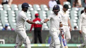 India's Ajinkya Rahane, right, and Cheteshwar Pujara walk out to bat on day four of the first Test between Australia and India.(AP) India's Ajinkya Rahane, right, and Cheteshwar Pujara walk out to bat on day four of the first Test between Australia and India.(AP)
