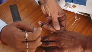 A polling officer puts indelible ink on the finger of a voter at a polling station in village Padampura, near Ajmer on December 7.(AP Photo) A polling officer puts indelible ink on the finger of a voter at a polling station in village Padampura, near Ajmer on December 7.(AP Photo)