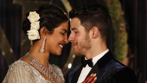 Priyanka Chopra and musician Nick Jonas pose for photographs at their wedding reception in New Delhi.(AP) Priyanka Chopra and musician Nick Jonas pose for photographs at their wedding reception in New Delhi.(AP)