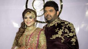 Kapil Sharma and his wife Ginni Chatrath pose during their wedding reception party at a hotel in Amritsar on December 14, 2018. (Photo by NARINDER NANU / AFP)(AFP) Kapil Sharma and his wife Ginni Chatrath pose during their wedding reception party at a hotel in Amritsar on December 14, 2018. (Photo by NARINDER NANU / AFP)(AFP)
