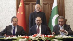 The MoU was signed by Pakistan’s foreign minister Shah Mehmood Qureshi and his Chinese and Afghan counterparts Wang Yi and Salahuddin Rabbani. The signing of the document was witnessed by Afghan President Ashraf Ghani.(AP) The MoU was signed by Pakistan’s foreign minister Shah Mehmood Qureshi and his Chinese and Afghan counterparts Wang Yi and Salahuddin Rabbani. The signing of the document was witnessed by Afghan President Ashraf Ghani.(AP)