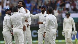 India's Ishant Sharma, third left, is swamped by teammates after he claimed the wicket of Australia's Peter Handscomb.(AP) India's Ishant Sharma, third left, is swamped by teammates after he claimed the wicket of Australia's Peter Handscomb.(AP)