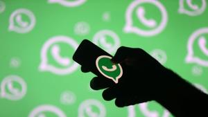 A man poses with a smartphone in front of displayed Whatsapp logo.(REUTERS) A man poses with a smartphone in front of displayed Whatsapp logo.(REUTERS)