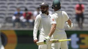 India's Virat Kohli, centre, looks to the umpire after he and opposing captain, Australia's Tim Paine came face to face in Perth.(AP) India's Virat Kohli, centre, looks to the umpire after he and opposing captain, Australia's Tim Paine came face to face in Perth.(AP)