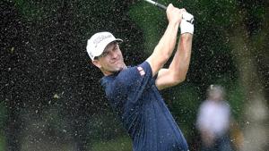 File image of Australia’s Adam Scott playing a shot as the rain falls.(Getty Images) File image of Australia’s Adam Scott playing a shot as the rain falls.(Getty Images)