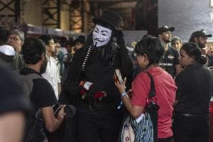 Fans interact with a person dressed as the eponymous protagonist from alan Moore’s graphic novel, V for Vendetta.(Aalok Soni)