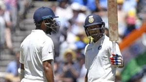 India's Mayank Agarwal, right celebrates with team mate, left Cheteshwar Pujara after scoring a half century on day one of the third cricket test between India and Australia in Melbourne.(AP) India's Mayank Agarwal, right celebrates with team mate, left Cheteshwar Pujara after scoring a half century on day one of the third cricket test between India and Australia in Melbourne.(AP)