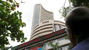 A man looks at a screen across a road displaying the Sensex on the facade of the Bombay Stock Exchange (BSE) building in Mumbai. Image for representation.(Reuters file photo) A man looks at a screen across a road displaying the Sensex on the facade of the Bombay Stock Exchange (BSE) building in Mumbai. Image for representation.(Reuters file photo)